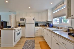 a kitchen with white cabinets and a white refrigerator at Sandpiper Shores in Florence