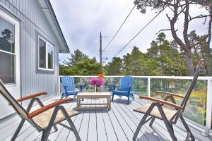 a porch with three chairs and a table on a house at Sandpiper Shores in Florence