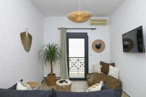a living room with a couch and a window at Rania Residence in Skopelos Town