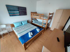 a bedroom with two bunk beds and a television at Vila Roza in Star Dojran
