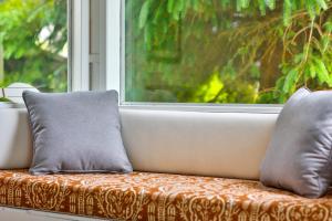 a couch with two pillows sitting in front of a window at Sandpiper Shores in Florence