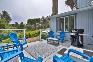 a patio with blue chairs and a grill at Sandpiper Shores in Florence