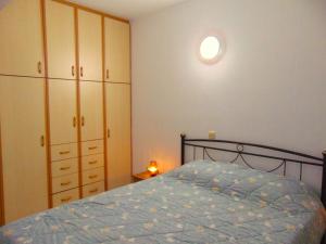 a bedroom with a bed with a blue comforter at Marilena Apartment, Keremies in Keramiaí