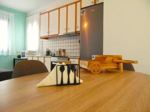 a kitchen with a wooden table and a kitchen with a refrigerator at Marilena Apartment, Keremies in Keramiaí