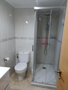 a bathroom with a toilet and a glass shower at Brisas del Mar in Salou