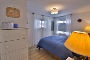 a bedroom with a bed and a dresser and a lamp at Sandpiper Shores in Florence