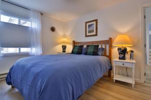 a bedroom with a blue bed and two lamps at Sandpiper Shores in Florence