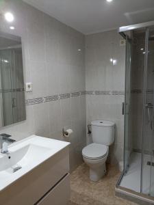 a bathroom with a toilet and a sink and a shower at Brisas del Mar in Salou