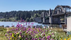a bridge over a body of water with flowers at Sandpiper Shores in Florence