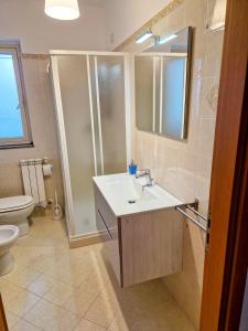 a bathroom with a sink and a shower and a toilet at PANORAMIC HOUSE -Santa Teresa di Riva- BANDIERA BLU in Santa Teresa di Riva
