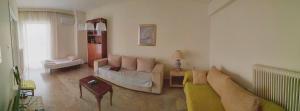 a living room with a couch and a table at Vangelis apartment near Athens Airport in Spata