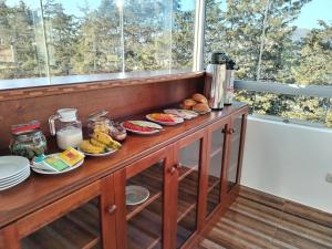 a wooden counter with plates of food on it at Dreams Boutique Hotel Cusco in Cusco