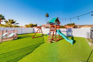 a playground with a slide on the grass at Pleasant Daydreams in Chandler