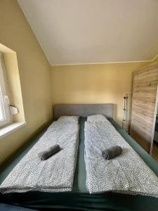 a bed with two pillows on it in a room at Moonlight Apartment in Siófok