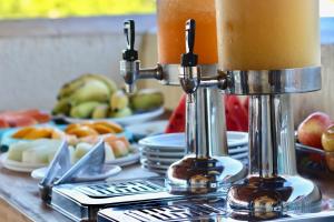 a table with two candles and plates of fruit at Pousada Sunbrazil in Jericoacoara