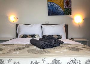Una cama con mantas y almohadas. en Seafront 2-bedroom apartment Nika - Rabac, en Rabac