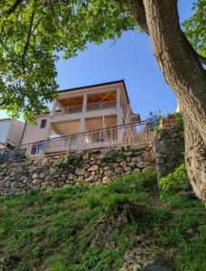 a house on top of a stone wall at Nika Seafront - Rabac, Istria in Rabac