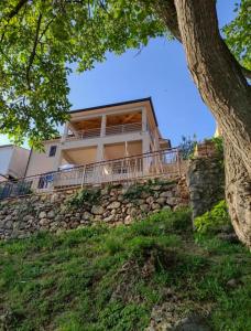 a house on top of a stone wall at Seafront 2-bedroom apartment Nika - Rabac in Rabac