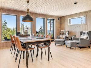 a dining room with a table and chairs at Holiday home Lampeland II in Lampeland