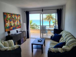 a living room with two couches and a view of the ocean at Acapulco Playa beautiful SeaView in Nerja