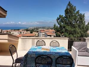 a table and chairs on a balcony with a view at Villa Rizzo in Castellammare del Golfo