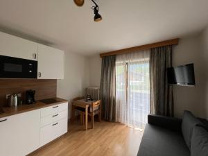 a living room with a couch and a table at Aparthotel Hochfeld in Schönau am Königssee