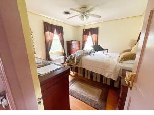 a bedroom with a bed and a ceiling fan at Welcome to your private cozy room #2 near LU, Stadium & general hospital in Lynchburg