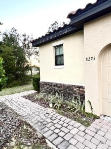 a house with a brick walkway in front of it at 8225RB-The Fountains at ChampionsGate townhouse in Kissimmee