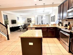 a kitchen with wooden cabinets and a counter top at 8225RB-The Fountains at ChampionsGate townhouse in Kissimmee