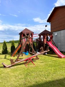 a group of playground equipment in a yard at Edelweiss House in Svityazʼ