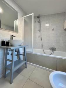a bathroom with a sink and a shower and a tub at Casa Robin in Montemarciano