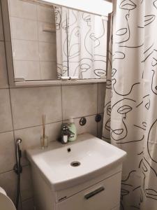 a bathroom with a sink and a mirror at Yyterin portti in Pori