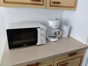 a kitchen counter with a microwave and a blender at Yyterin portti in Pori