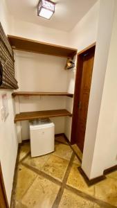 a laundry room with a washer and dryer on a wall at Pousada Sunbrazil in Jericoacoara