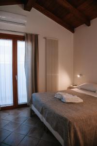 a bedroom with a bed with towels on it at Magnolia Rooms in Civitavecchia