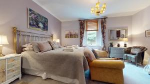 Un dormitorio con una cama, una silla y una lámpara de araña. en Elgin Tower apartment, en Minehead