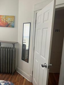 a door in a room with a mirror and a radiator at Hollywood Rentals LLC in Chicago
