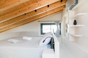 a room with a bed in a house with wooden ceilings at Villa Tempestini in Nikiana