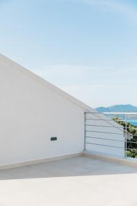 a white room with a door and a view of the ocean at Villa Tempestini in Nikiana