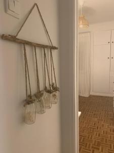 a group of glass jars hanging on a wall at Apt 20 min from downtown train in Amadora