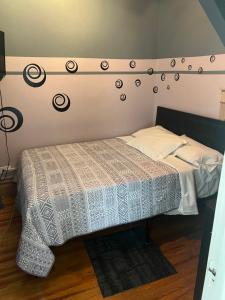 a bedroom with a bed with a white comforter at Hollywood Rentals LLC in Chicago