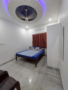 a room with a blue bed and a ceiling at Entire Villaa in Jodhpur