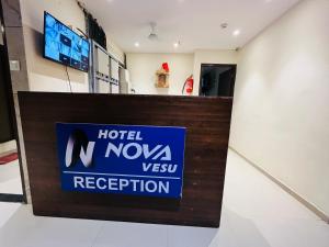 a sign for a hotel nova vegas reception at Hotel Nova Vesu in Surat