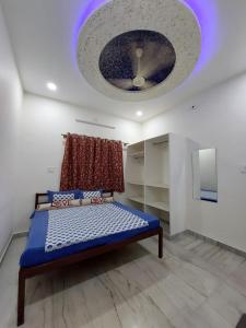 a bedroom with a blue bed and a ceiling at Entire Villaa in Jodhpur