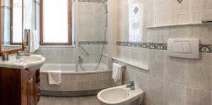 a bathroom with a sink and a toilet and a tub at Hotel Villa Venezia in Grado +66 photos