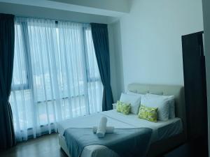 a bedroom with a large bed and a large window at ASTRA at Opus Residences Kuala Lumpur in Kuala Lumpur