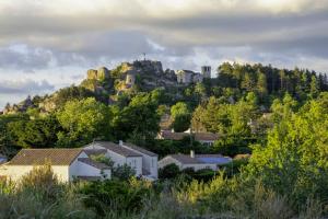 a town on a hill with a castle on it at Le Rockastel in Le Caylar