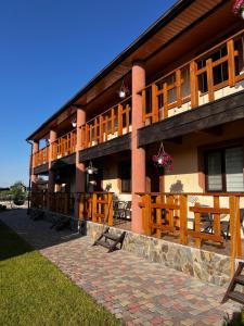 a building with tables and benches in front of it at Edelweiss House in Svityazʼ