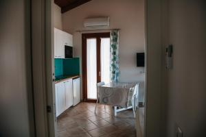 a kitchen with a table in the middle of a room at Magnolia Rooms in Civitavecchia