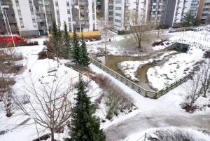 a park covered in snow in front of a building at Studio by Sello shopping mall in Espoo